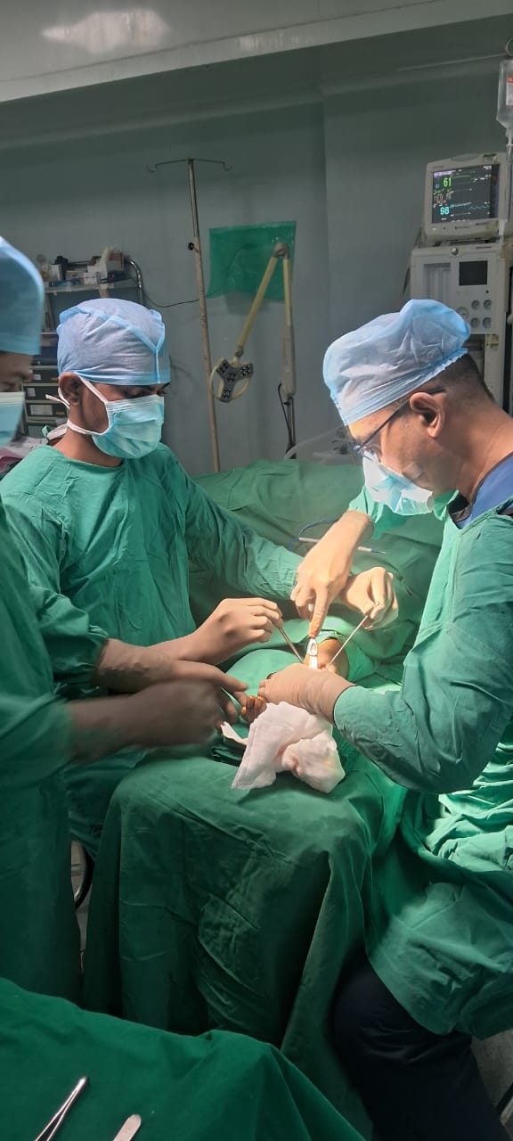 Surgical team performing a medical procedure in an operating room, associated with Ravi Chavan, founder of AashaWorld